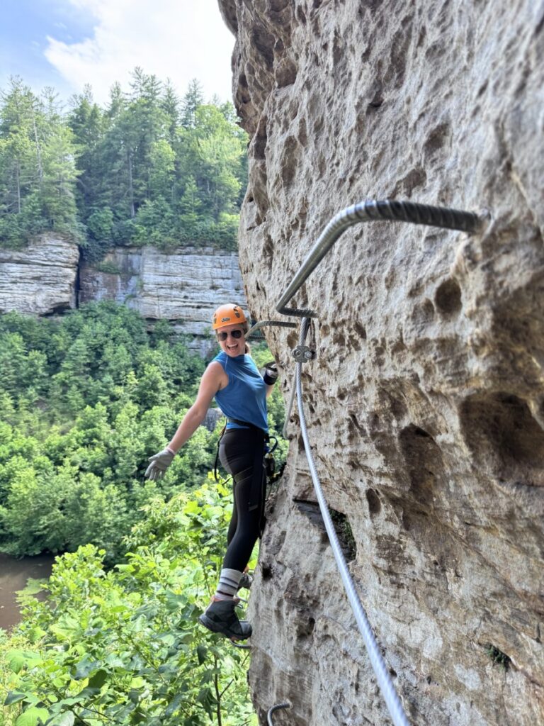 Girl climbing on Red River Gorge Via Ferrata