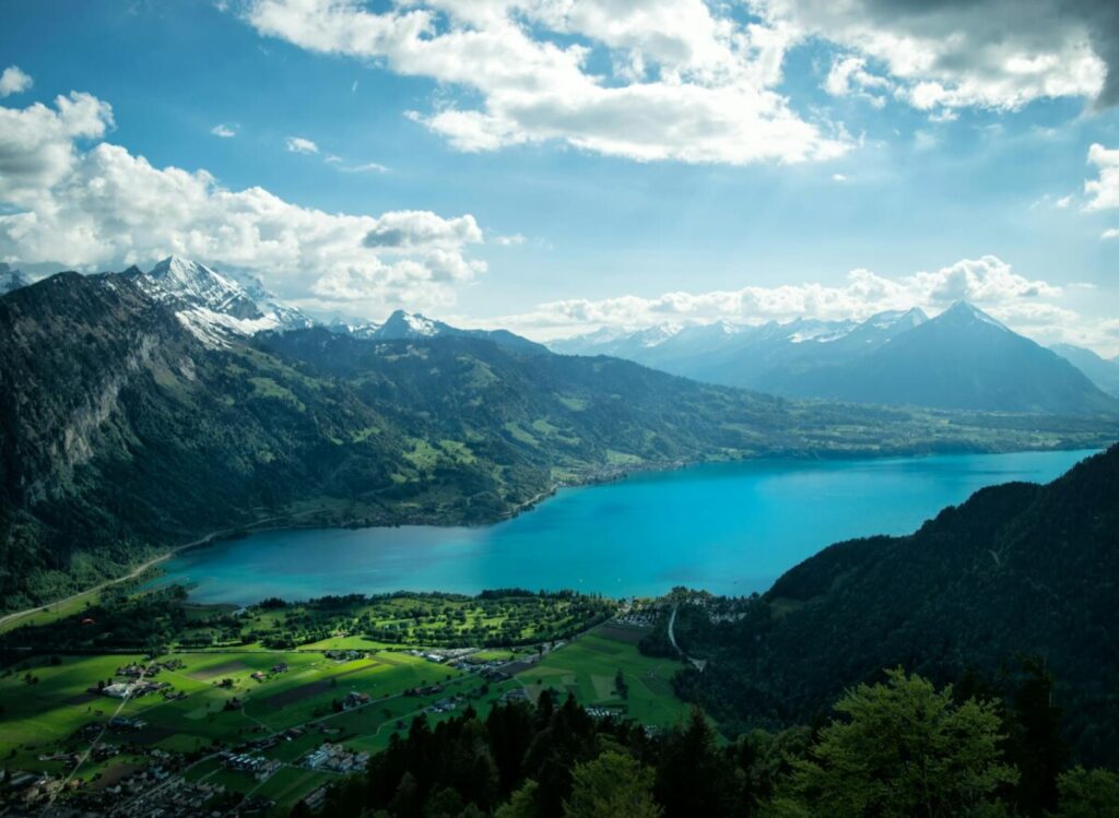 Scenic aerial view showcasing Lake Thun and the surrounding Swiss Alps in Interlaken, Switzerland.