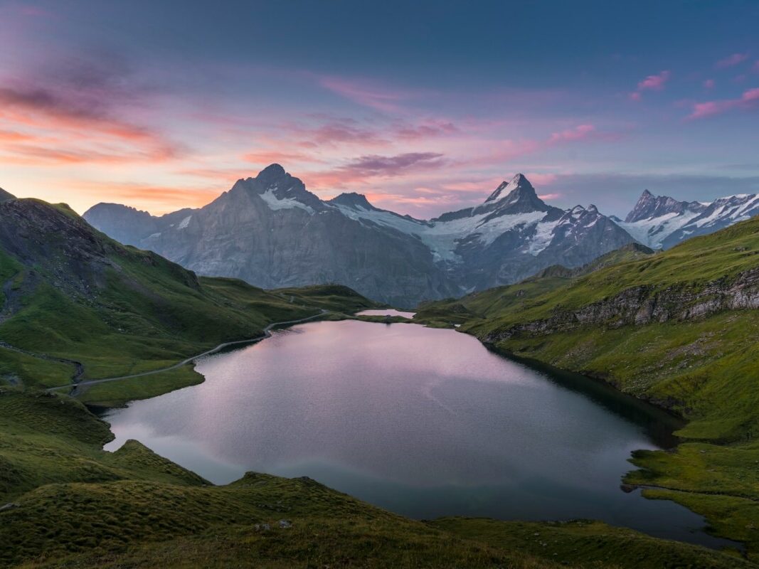 lake in the middle of green mountains